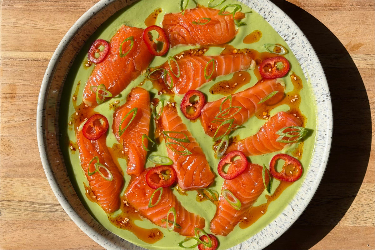 Spicy green salmon crudo: King Salmon slices on avocado-lime dressing with Fresno chile, green onion and salsa macha