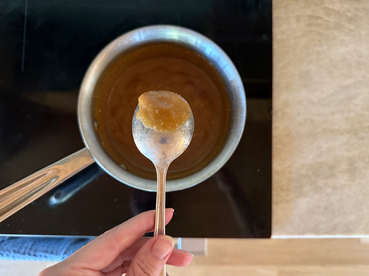 Sake, miso paste and coconut sugar simmering in a saucepan and reducing into a glaze