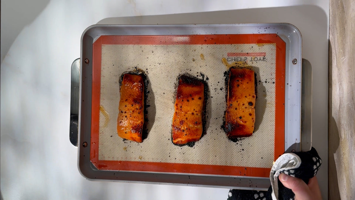 Broiled miso-glazed king salmon resting on the baking sheet after coming out of the oven