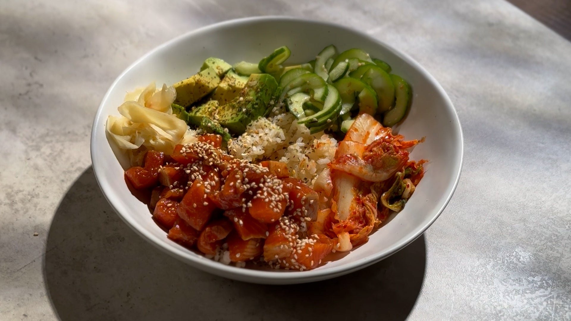 A vibrant poke bowl featuring Seatopia New Zealand King Salmon, sushi rice, avocado, and garnishes in a fresh, colorful presentation.
