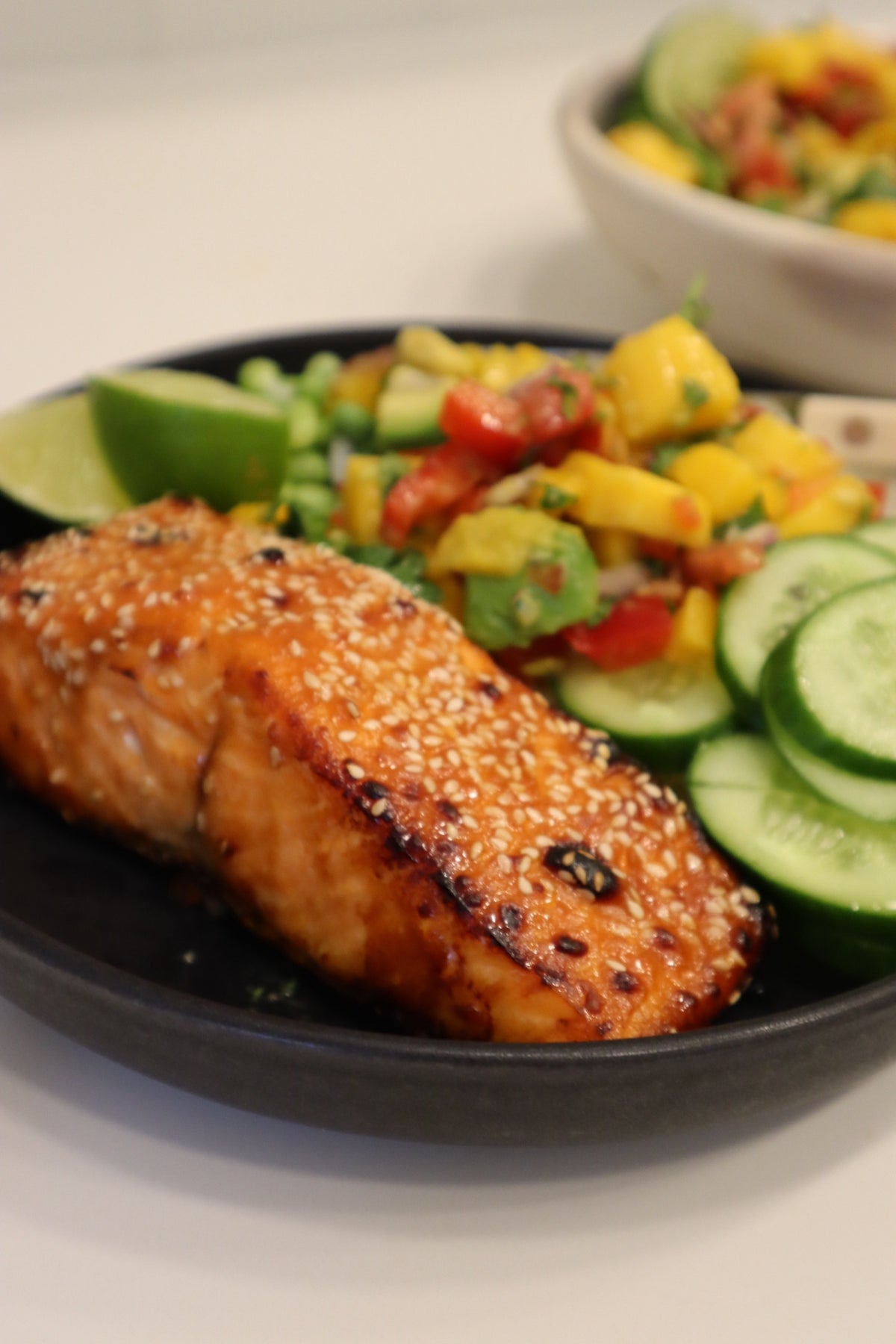 Close-up of a caramelized hot honey glazed salmon fillet crusted with sesame seeds